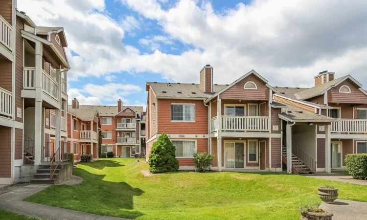 Chateau Rainier Salmon-colored two- and three-story apartments surround grassy courtyard areas.